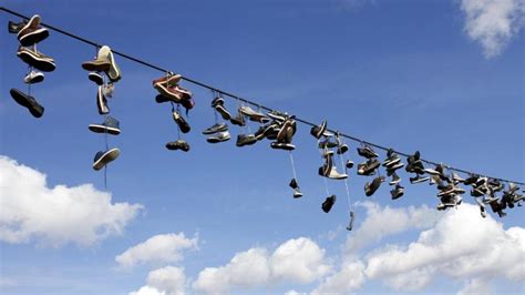 why are there shoes on power lines|hanging shoes.